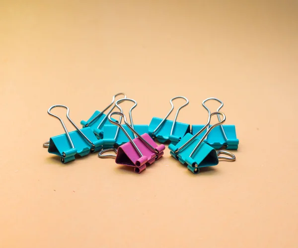 colorful binder clips : office supply on background.