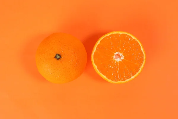 Mandarin Orange Fruit slice half on orange background