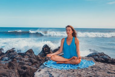 Genç kadın bir uçurum, o lotus bulunduğu meditasyon yoga pratik.