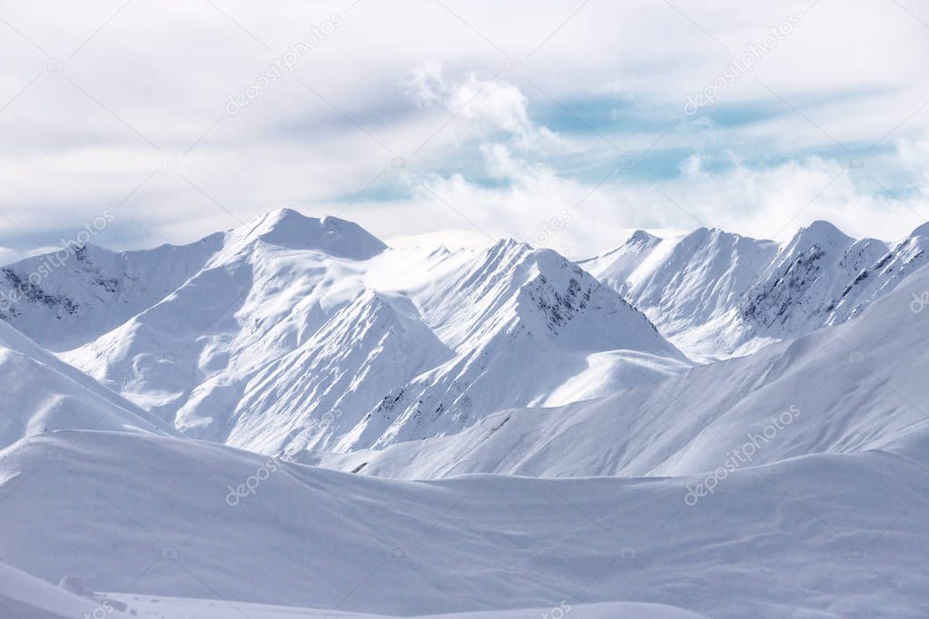 The peaks of snowy Caucasus mountains in The Gudauri Ski Resort, Georgia. Snowboarding in The Gudauri Ski Resort, Georgia.