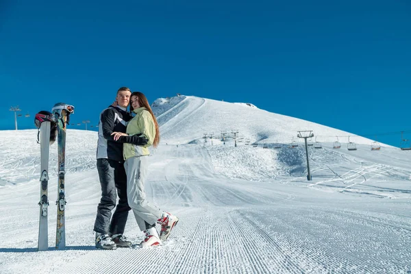 Couple with ski equipment spending winter vacation in mountains