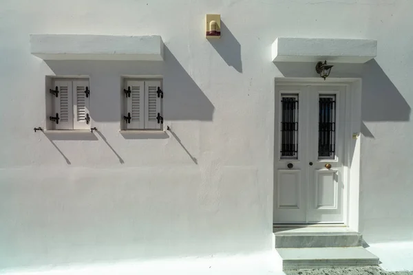 Antique white locked door and two window colonial style on white wall — Stock Photo, Image