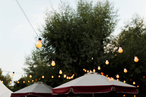 проволоки с подогревом лампочки висит в области празднования свадебных событий в ночь
