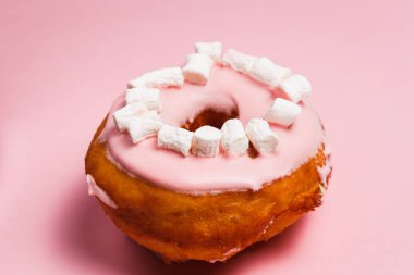 Pembe bir arka plan üzerinde marshmallow ile pembe çörek