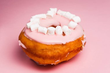 Pembe bir arka plan üzerinde marshmallow ile pembe çörek