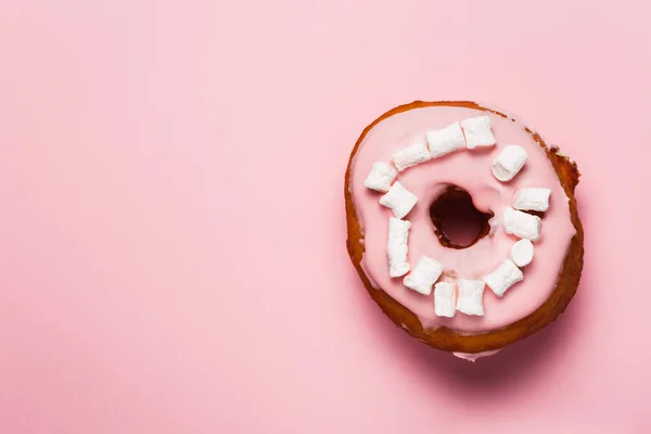 Pink donuts with marshmallows. Pink donut stock images. Donut on a Pink background. Donut isolated on a Pink background.