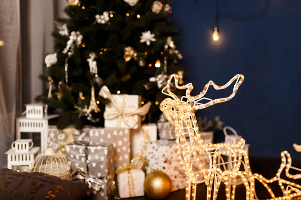 garland Christmas sleigh with Christmas deer glows against the night sky