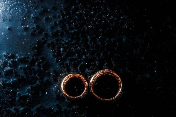 Belos anéis de casamento no fundo escuro — Fotografia de Stock