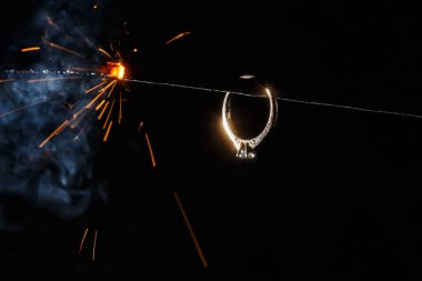 Yanan bengal ışığında düğün nişan yüzüğü