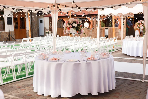 Tables for guests decorated at the banquet