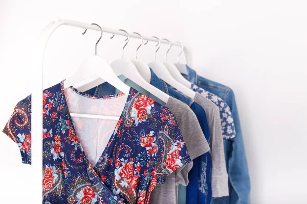 Summer, autumn, spring clothes hanging on a rack, trending concept