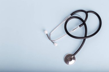 Mavi arka planda steteskop düz fotokopi alanı medikal konsepti