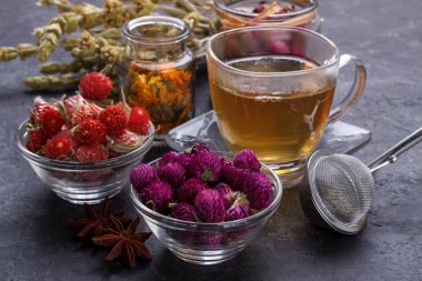 Sağlıklı çay için bitkiler ve kuru çiçekler siyah taş arka plan fotokopi alanı