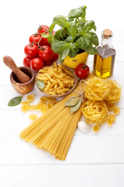 Raw Pasta Ingredients White Background Tomatoes Basil Olive Oil Spaghetti — Stock Photo, Image