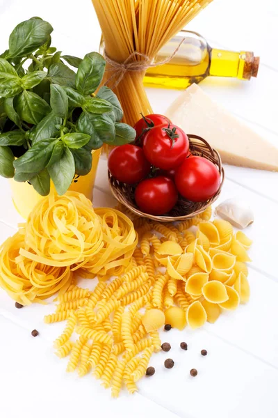 Raw Pasta Ingredients White Background Tomatoes Basil Olive Oil Spaghetti — Stock Photo, Image