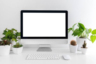 Beyaz modern masaüstü bilgisayar ve bitkiler ile. Öğrenci veya serbest meslek sahibi, sahte kadar minimalist işyeri