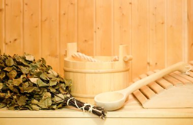 Tahta bir kova, bir huş süpürge ve diğer aksesuarları bir klasik Fin saunası veya Rus banyosu. Ahşap arka plan üzerinde boş alan