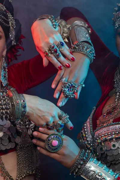 Hand movement, Belly dancers, Indian dancers and flamenco dancers close up cropped photo Knitted suits, vintage Indian layered skirts, Afghani, ancient Yemeni jewelry, many colors, iron and wealth.