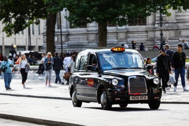 Legendary London taxi cab on the streets of London clipart