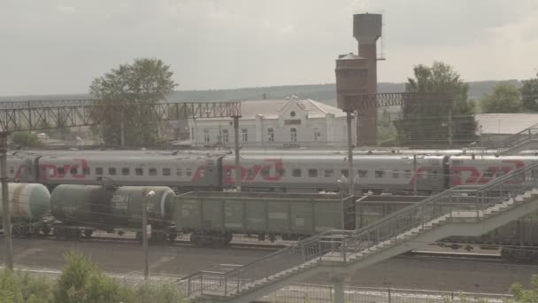 Treno passeggeri a lunga percorrenza e treno merci sulla piccola stazione Uzunovo. RZD — Video Stock