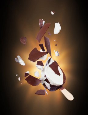 Chocolate ice cream crushed into pieces in the dark clipart