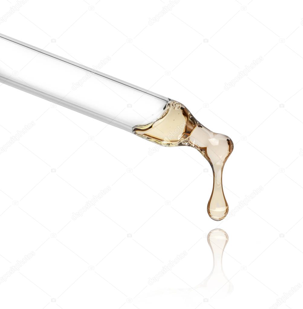 Liquid drop from cosmetic pipette close up, isolated on white background