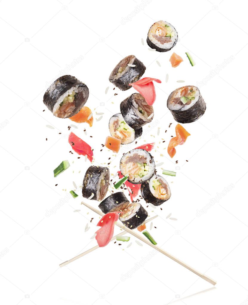 Sushi with chopsticks chaotically hovering in the air on white background 