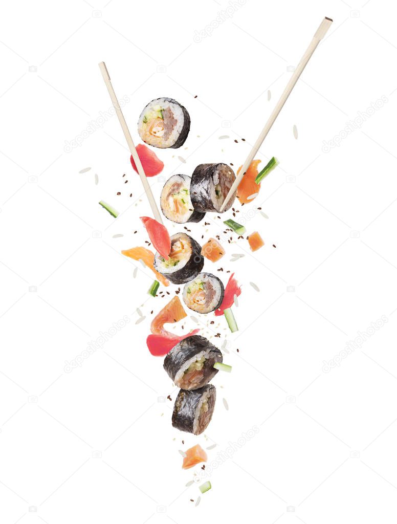 Fresh sushi rolls with chopsticks frozen in the air, isolated on white background 