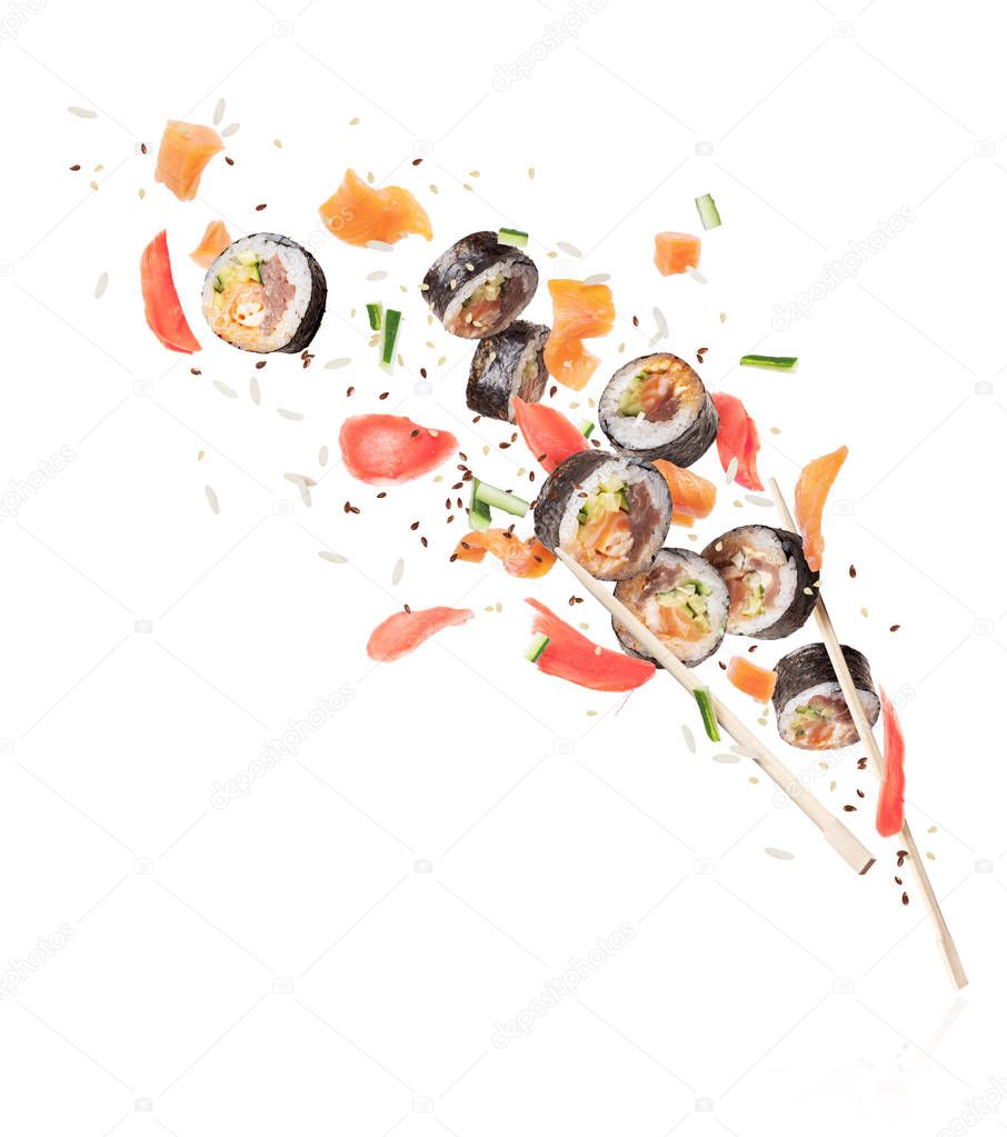 Fresh sushi rolls with chopsticks frozen in the air, image in high resolution on a white background