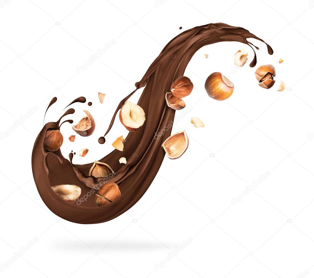 Splash of melted chocolate with crushed hazelnuts on white background