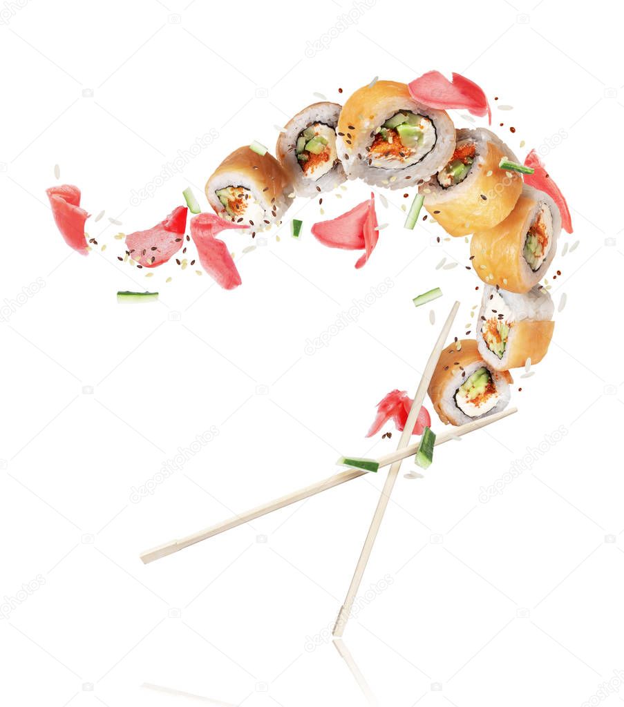 Fresh sushi rolls with ginger frozen in the air on white background 