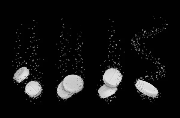 Conjunto de pastillas solubles en agua de primer plano sobre fondo negro —  Fotos de Stock