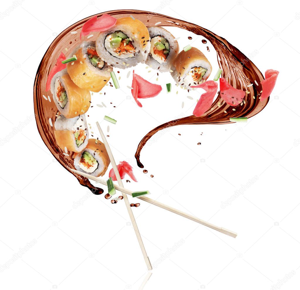 Fresh sushi rolls with splashes of soy sauce, frozen in the air on white background 