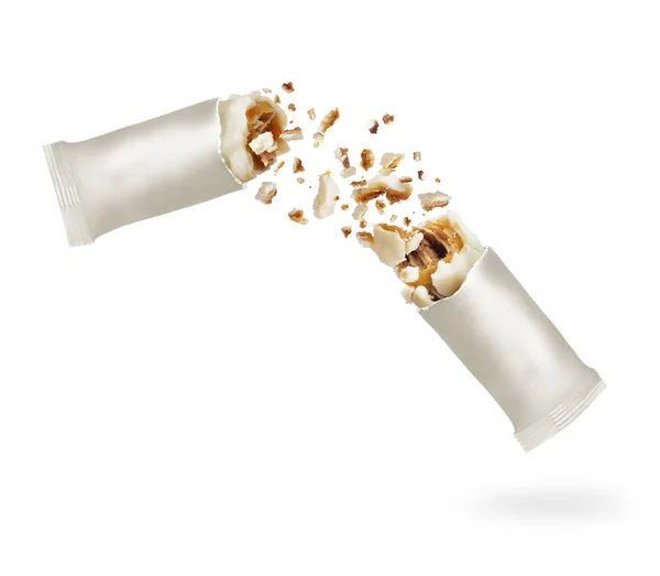 Milk chocolate bar with nuts crushed in the air, isolated on a white background — Stock Photo, Image
