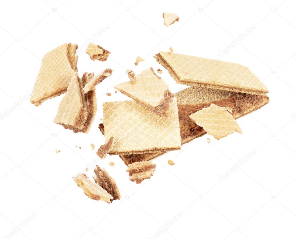 Waffle crushed into pieces in the air, isolated on white background