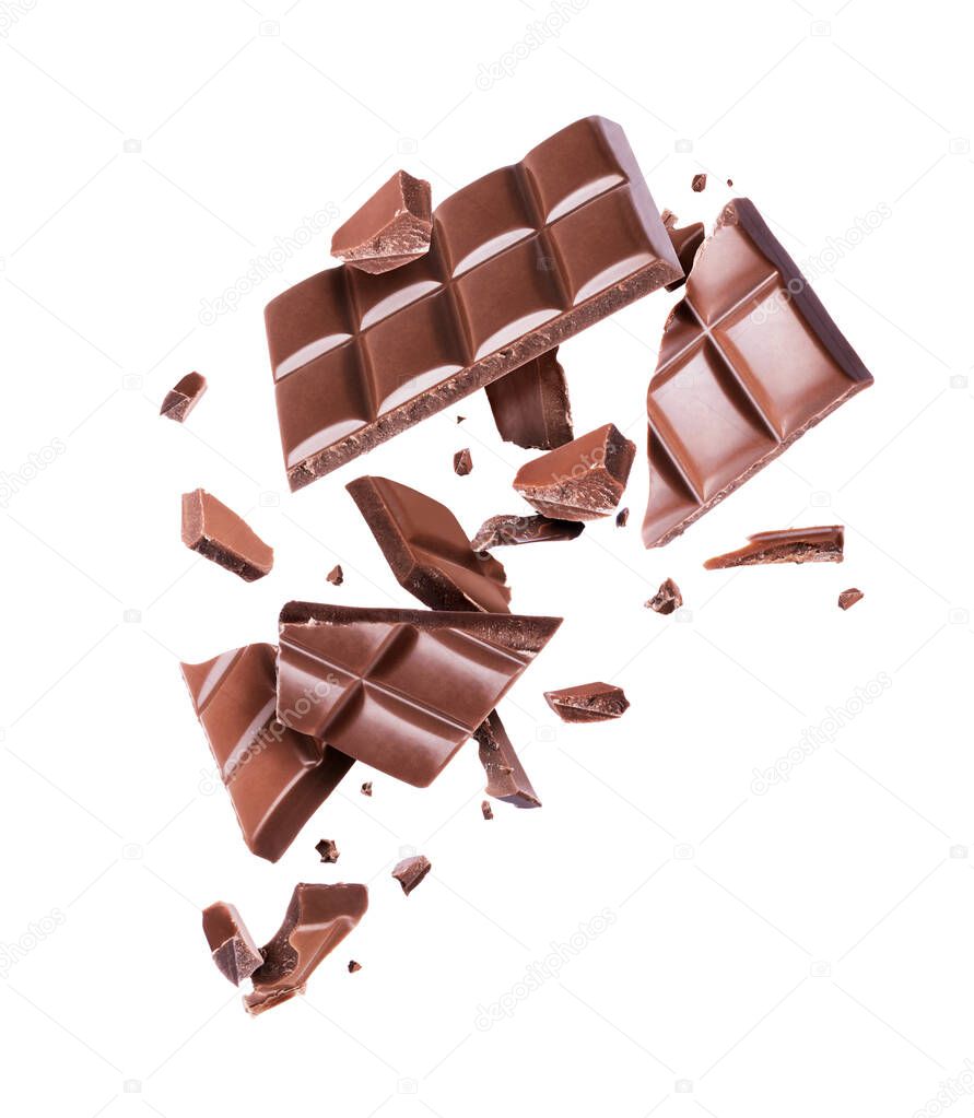Chocolate broken into many pieces in the air on a white background 