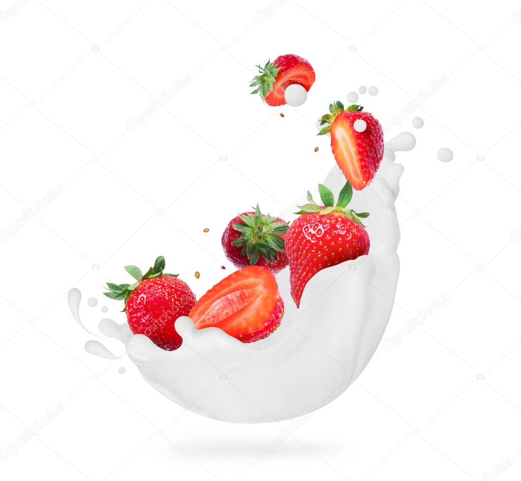 Whole and sliced strawberries with milk splashes close-up isolated on white background