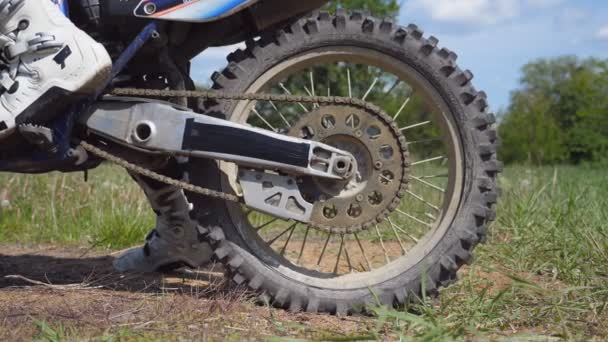 Wheel of motocross bike starting to spin and kicking up ground or dirt. Motorcycle starts the movement. Slow motion Close up — Stock Video
