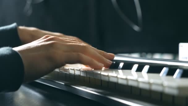 Close up fingers of pianist at the piano keys. Mens arms plays solo of music or new melody. Hands of male musician playing at synthesizer. Slow motion Top view Isolated shot — Stock Video