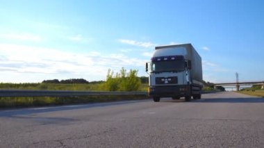 Kamera bir otoyolda sürüş kamyon aşağıda verilmiştir. Arka plan, güzel manzara ile kırsal yoluyla kamyon sürmek. Yan görünümü ağır çekim yakın çekim