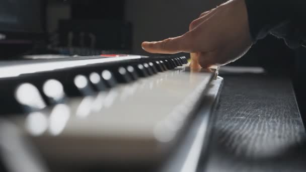 Fingers of pianist pressing at synthesizer keys. Work in sound studio. Male hands playing at piano. Side view Slow motion Close up — Stock Video