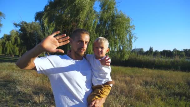 Portrait Happy Father Little Son Waving Hands Camera Park Young — Stock Video