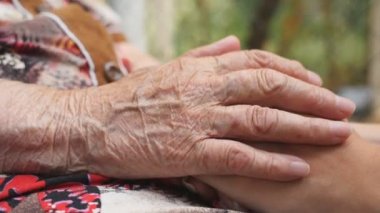 Dışarıda genç bayanların kollarını okşayan yaşlı kadınların eli. Torunumla büyükannem dışarıda vakit geçiriyorlar. İlgi ve sevgi kavramı. Yan Görünümü Kapat Yavaş Çekim