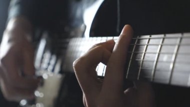 Erkek müzisyen elektro gitar çalmak kollarına. Dizeleri tıngırdatmaya gitarist parmakları kadar kapatın. Rock müzik solo performans adam elinde. Yetişkin adam bir müzik aleti çalıyor. Ağır çekim