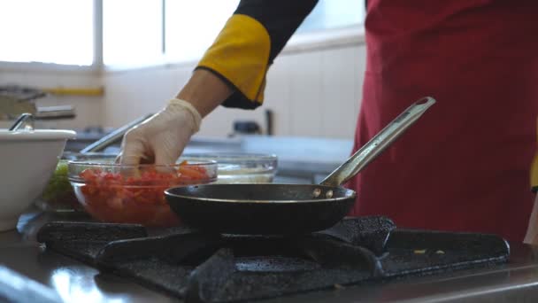 Μη αναγνωρίσιμος σεφ που μαγειρεύει νόστιμο χορτοφαγικό πιάτο για επισκέπτες εστιατορίων. Αρσενικό μαγείρεμα που πετάει συστατικά σε καυτό τηγάνι σε σόμπα αερίου. Θέα στη διαδικασία μαγειρικής στην κουζίνα του εστιατορίου. Κάτω όψη αργός — Αρχείο Βίντεο