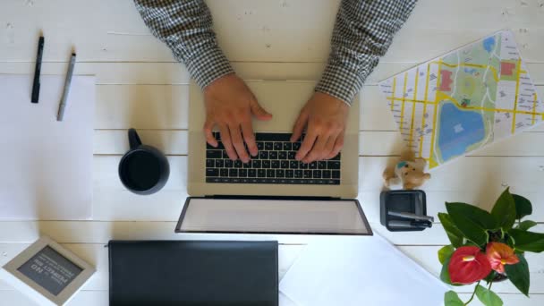 Top view on male hands typing text on laptop keyboard at white wooden desk. Creative businessman celebrating achievement or rejoicing success. Businessperson working in modern office. Slow mo Close up — Stock Video