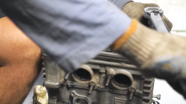 Mecânico irreconhecível reparação automóvel motor usando a ferramenta. Auto motor de fixação mestre do veículo. Homem envolvido na manutenção de automóveis. Reparador que trabalha em garagem ou oficina. Lento movimento Fechar — Vídeo de Stock