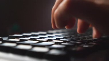 Bilgisayar klavyesindeki düğmelere basan erkek parmaklarını kapat. Yeni projede PC yazma metnini kullanarak çalışan tanınamaz bir serbest yazar. Verimli bir gece çalışması. Arka plan bulanık. Yavaş çekim
