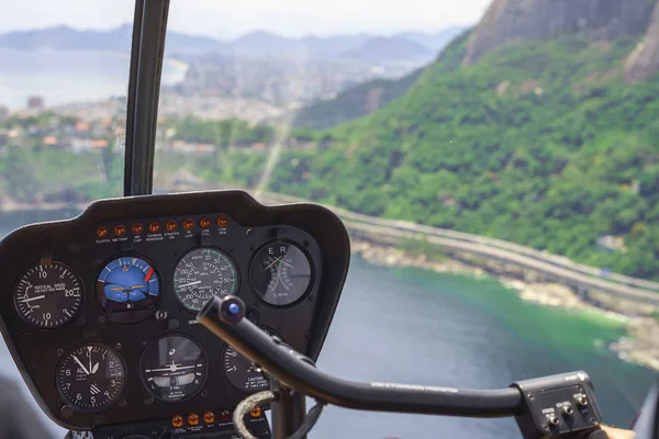 View from a helicopter cockpit flying over Rio de Janeiro. Cockpit with instruments panel. Captain in the aircraft cockpit. — Stock Photo, Image