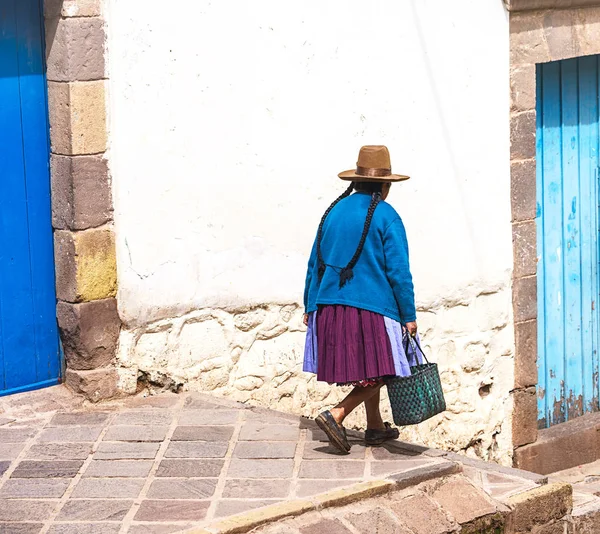 Peruvian elderly woman in traditional dress on the street of Cusco, Peru, Latin America. horizontal, brown hat